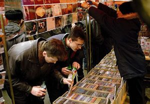 Men browsing media at Gorbushka.